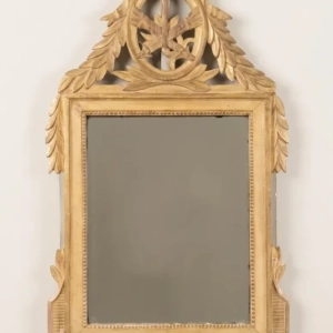 A beautiful Louis XVI style, gilded wood mirror with quiver, torch, ribbons and garlands. Original mercury glass. 19th century.