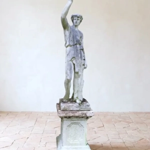 Large statue of a young Hercules on plinth.