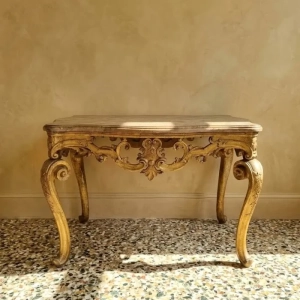 A beautifully carved, gilded wood Venetian centre table, with faux marble top. Scrolled legs, elaborate pierced skirt. A stunning piece. 18th century.
