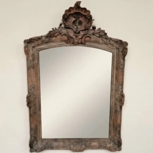 A gorgeous stripped oak Regence period mirror. Decorated with shells, foliage and flowers. Circa 1720.