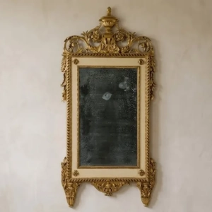 An impressive, carved wood, lacquered and gilded mirror. Late 18th century.