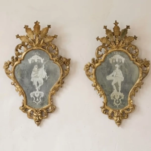 A beautiful pair of Venetian engraved mirrors in carved giltwood frames.