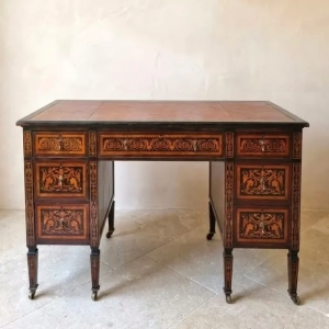 An exceptional Neoclassical marquetry, writing desk. Inlay decorations of urns, palmettes, garlands, ribbons and foliage. Seven drawers with eight tapered legs. Gold embossed Moroccan leather top. Ebony and fruitwoods. General wear marks. Italian, late 18th century.