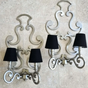A decorative pair of baroque style wall sconces.