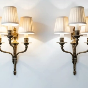 An attractive set of three light wall sconces with pleated shades.