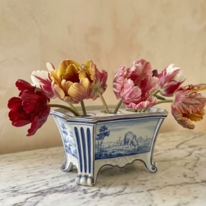 A charming ceramic tulip vase, decorated in a camaïeu de bleu ( tones of blue ) with landscapes and floral designs.